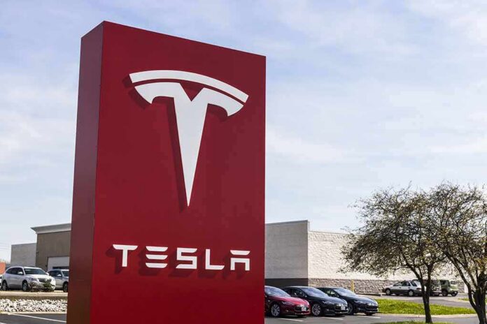 Tesla dealership sign in front of parking lot