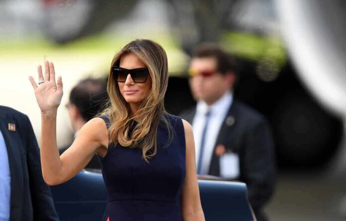 Melania Trump waving while wearing sunglasses outdoors